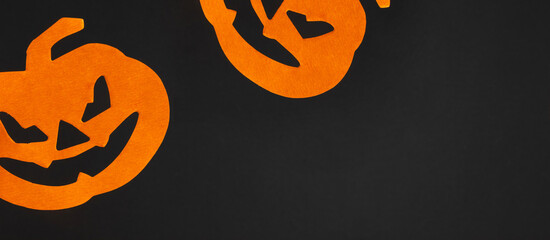 Halloween background. Flat lay. Top view of Halloween decorations with orange pumpkins on black background. Halloween concept