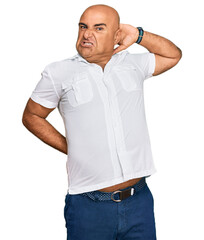 Fototapeta premium Mature middle east man with mustache wearing casual white shirt suffering of neck ache injury, touching neck with hand, muscular pain
