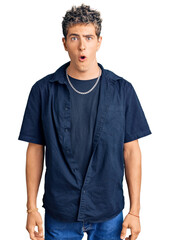 Young handsome man wearing casual clothes scared and amazed with open mouth for surprise, disbelief...