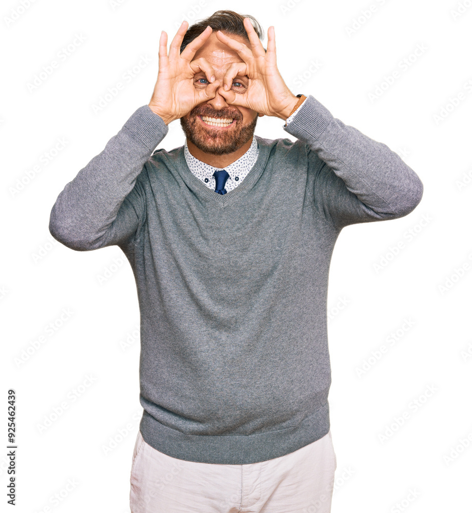 Sticker Handsome middle age man wearing business clothes doing ok gesture like binoculars sticking tongue out, eyes looking through fingers. crazy expression.