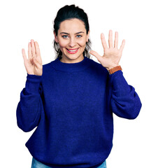 Young hispanic woman wearing casual clothes showing and pointing up with fingers number nine while...