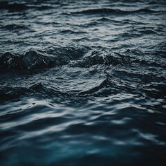 Obraz premium Gentle waves creating a soothing rhythm on the surface of a quiet, sandy beach at sunrise