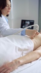 Female doctor using ultrasound machine examining patient abdomen and heart