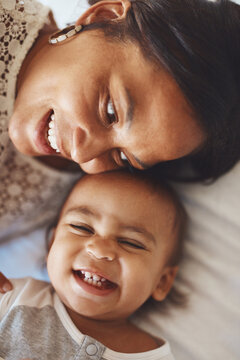 Above, mom and baby in bedroom with love, maternal or hug care and support for growth or development. Mother, boy toddler and together in house for bonding, emotional connection and wellness.