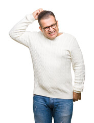 Fototapeta premium Middle age arab man wearing glasses over isolated background confuse and wonder about question. Uncertain with doubt, thinking with hand on head. Pensive concept.