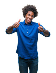 Afro american man over isolated background approving doing positive gesture with hand, thumbs up smiling and happy for success. Looking at the camera, winner gesture.