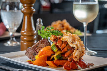 Surf & Turf - Cold water lobster tail and 6oz petite filet, drawn butter and grilled lemon with...