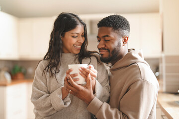 Happy Couple Sharing Warm Drink in Modern Kitchen During Cozy Afternoon