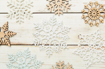 Beautiful snowflake on woden background, top view