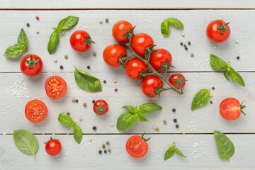 Fresh tomatoes, basil, sea salt and spices on wooden background, top view