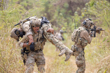 oldier carried the injured fellow  from the mission in the forest