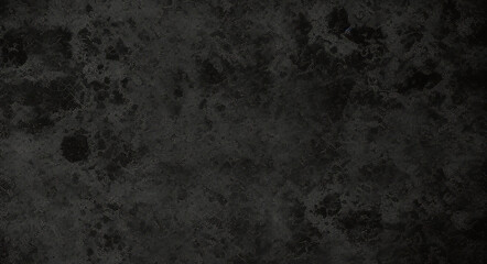 Black background made of real, shiny black paper covered with foil, illuminated by a soft light from above.	