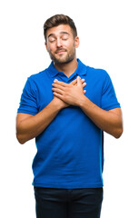 Young handsome man over isolated background smiling with hands on chest with closed eyes and grateful gesture on face. Health concept.