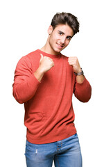 Young handsome man over isolated background looking confident with smile on face, pointing oneself...