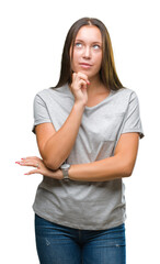 Young caucasian beautiful woman over isolated background with hand on chin thinking about question, pensive expression. Smiling with thoughtful face. Doubt concept.