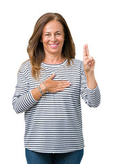 Beautiful middle age woman wearing stripes sweater over isolated background Swearing with hand on...