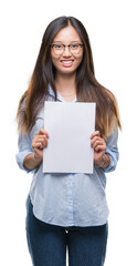 Naklejka premium Young asian woman holding blank paper over isolated background with a happy face standing and smiling with a confident smile showing teeth