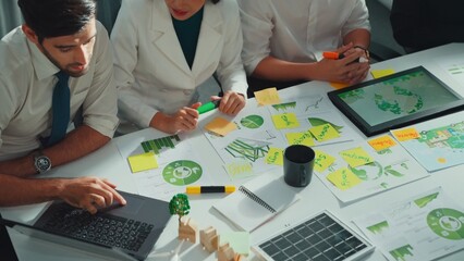 Close up of business people hands write notes about sustainable energy and environmental idea....