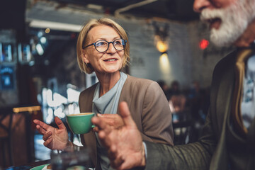 Mature Woman and Senior Man couple Bond Over Coffee at Cafe sit talk
