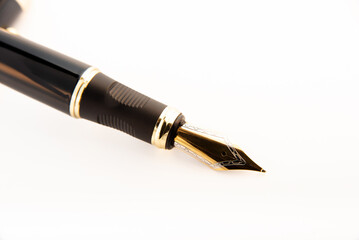 Fountain pen, beautiful fountain pen positioned on white background, selective focus.