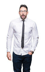 Fototapeta premium Young handsome business man wearing glasses over isolated background afraid and shocked with surprise expression, fear and excited face.