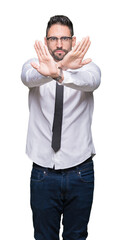 Fototapeta premium Young handsome business man wearing glasses over isolated background Rejection expression crossing arms and palms doing negative sign, angry face