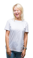 Young beautiful blonde woman wearing white t-shirt over isolated background winking looking at the...