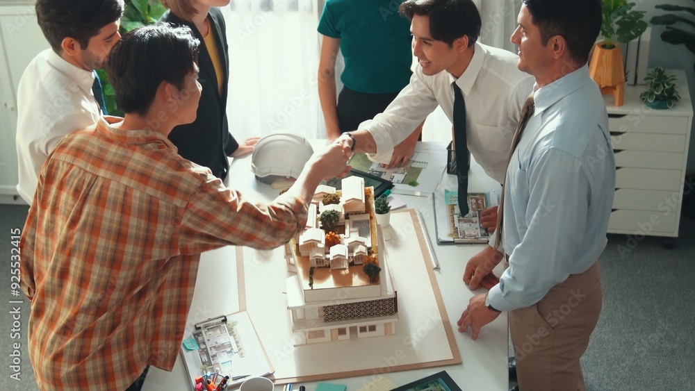 Poster top view of manager shake hands and making a deal at meeting table with architectural model, bluepri