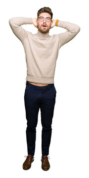 Young handsome business man wearing glasses Crazy and scared with hands on head, afraid and surprised of shock with open mouth