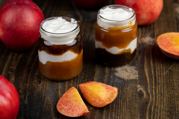 fresh yogurt with jam and pieces of ripe nectarine