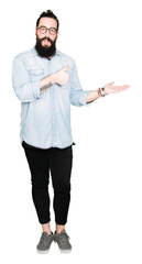 Young hipster man with long hair and beard wearing glasses Showing palm hand and doing ok gesture with thumbs up, smiling happy and cheerful