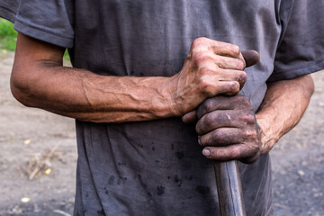 Dirty worker hands. Charcoal burner with dirty hands.