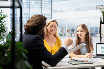 Counselor helping family members build financial plan based on economic goals and available cash...