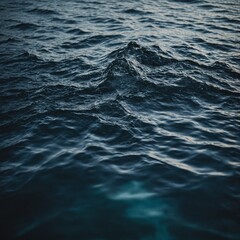 The still surface of a tranquil lake reflecting the snow-capped peaks of surrounding mountains