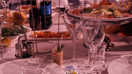 Glasses with champagne at a buffet table in a restaurant, side view