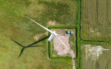 top down birds eye aerial view of a wind turbine in a small rural wind farm in the English countryside