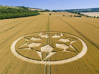 Aerial view of an intricate geometric crop circle formation in a wheat field near Marten in Wiltshire, England, UK