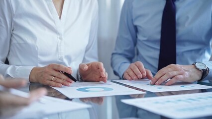 Business people are reviewing a financial results and discussing the terms of the agreement. Teamwork and planning
