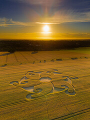 Aerial view of an intricate geometric crop circle formation in a wheat field near Etchilhampton and Devizes in Wiltshire, England, UK