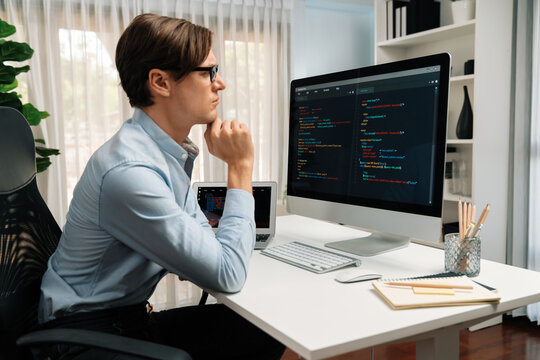 IT developer looking at online software development information on pc align working laptop with coding program on updated version application project trial creating new code overall system. Pecuniary.