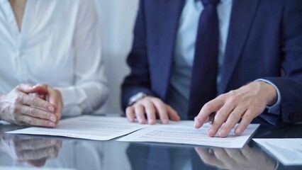 Diverse business people discussing contract papers before signing. Teamwork of lawyers