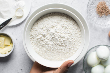 overhead view of All purpose flour in a white bowl, baking flour in a bowl