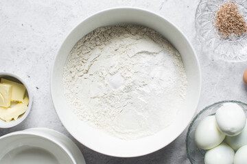 overhead view of All purpose flour in a white bowl, baking flour in a bowl