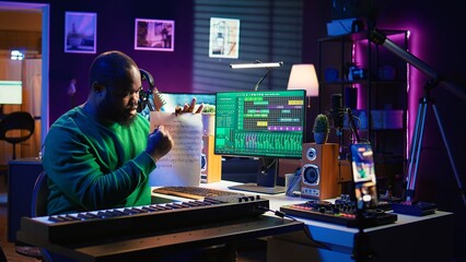 Talented composer explaining musical sheet notes during online master class recorded with smartphone in home studio. Artist musician teaching people how to read and sing accords on piano. Camera B.