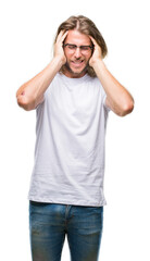 Fototapeta premium Young handsome man with long hair wearing glasses over isolated background with hand on head for pain in head because stress. Suffering migraine.