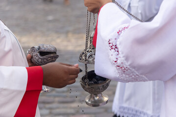 Catholic faithful are seen lighting incense during the Sacred Heart of Jesus procession in...