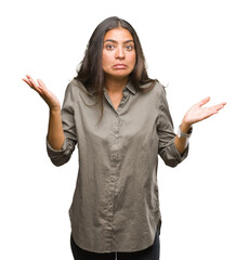 Young beautiful arab woman over isolated background clueless and confused expression with arms and...