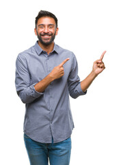 Adult hispanic man over isolated background smiling and looking at the camera pointing with two hands and fingers to the side.