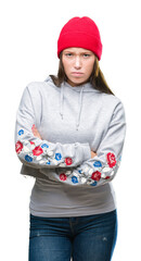 Young caucasian beautiful woman wearing wool cap over isolated background skeptic and nervous,...