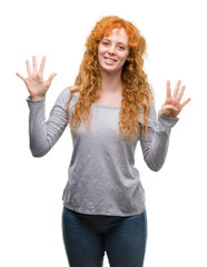 Young redhead woman showing and pointing up with fingers number nine while smiling confident and...